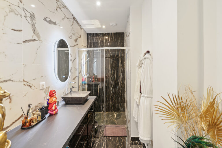 Luxury marble bathroom with a spa bath after apartment renovation in the French Riviera